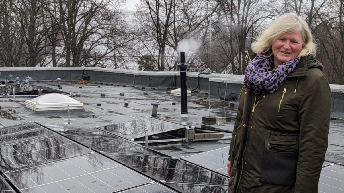 Zoomitarbeiterin Heike Schroers auf dem Dach der Futtermeisterei, auf der eine PV-Anlage installiert ist. Foto: Stadt Krefeld, Presse und Kommunikation